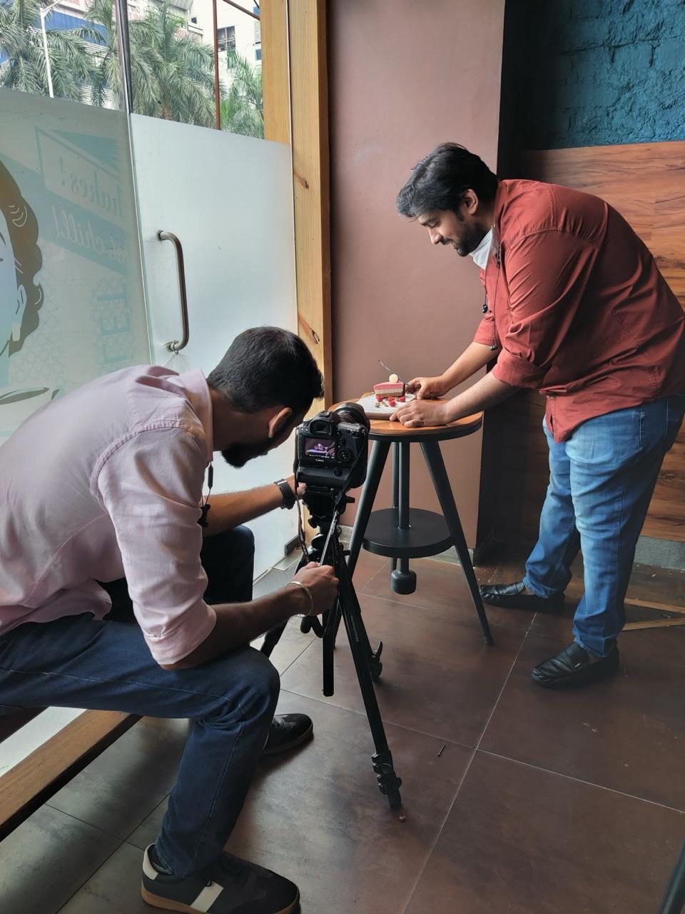 MK Studios crew setting up a camera on a tripod before a shoot
